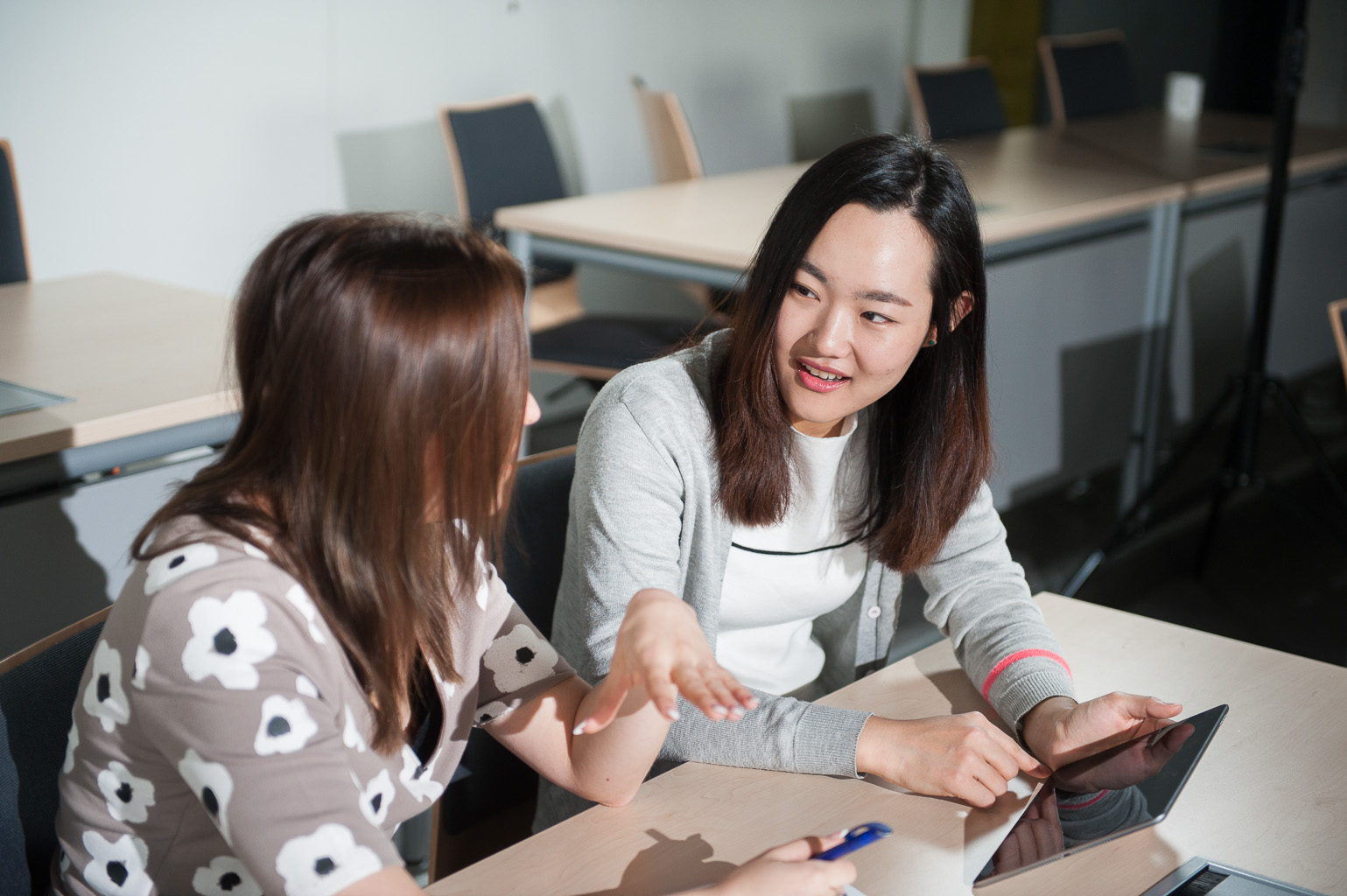 Students chatting in a lecture room.