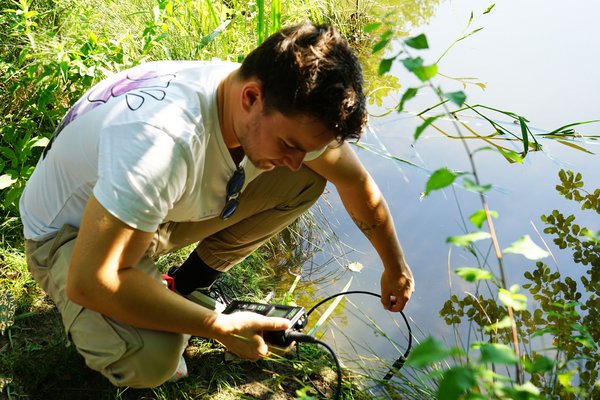 Student takes water sample